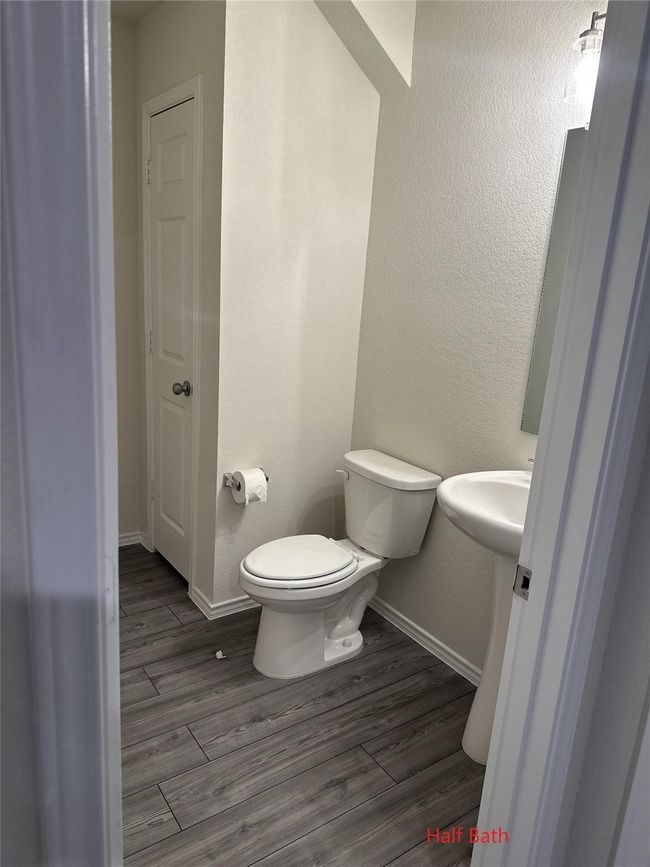Half bathroom with wood finished floors and toilet | Image 4