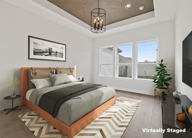 Bedroom featuring a chandelier, baseboards, a raised ceiling, and wood finished floors | Image 16