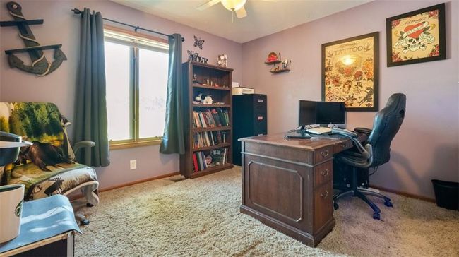 Carpeted office space with a ceiling fan and baseboards | Image 15
