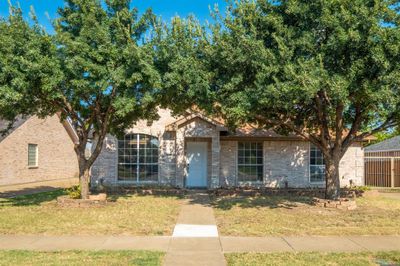 View of front of house featuring a front yard and a garage | Image 1