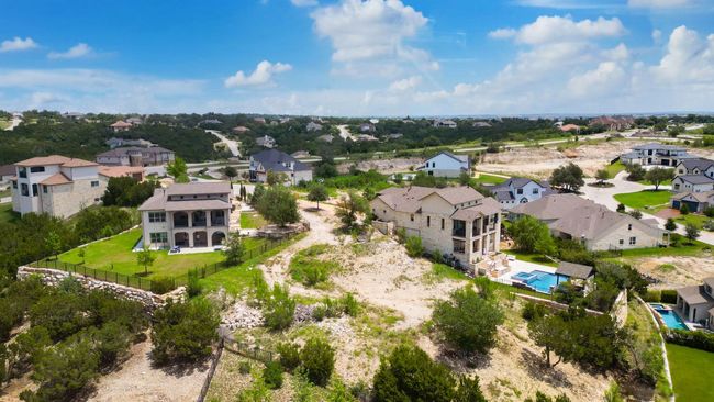 Aerial view of property and surrounding area featuring nearby suburban area and a pool | Image 13