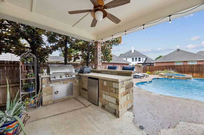 Fenced backyard featuring an outdoor kitchen, a patio area perfect for entertaining | Image 34