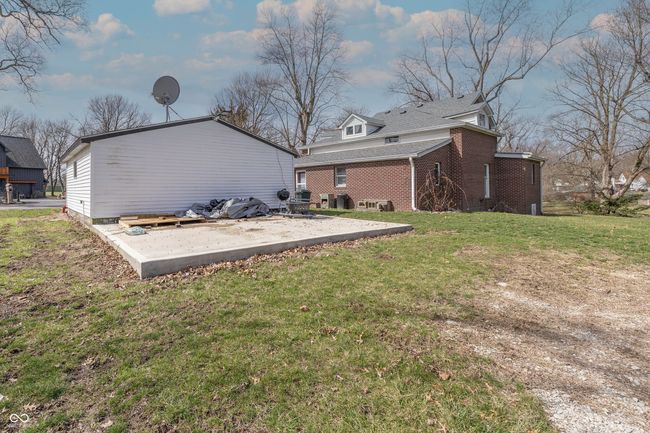 rear view of property with brick siding, a lawn, and a patio | Image 20