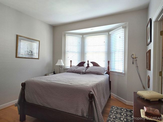 Bedroom featuring wood finished floors and baseboards | Image 38