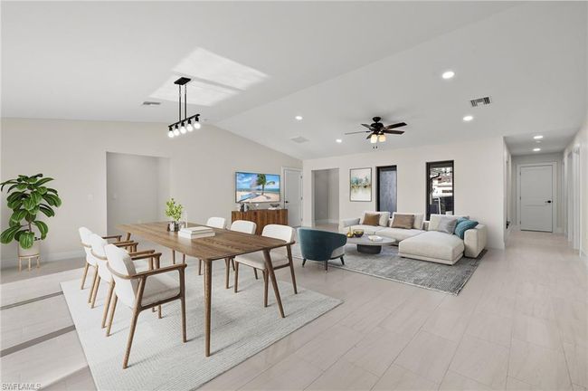 Dining space featuring ceiling fan and lofted ceiling | Image 6