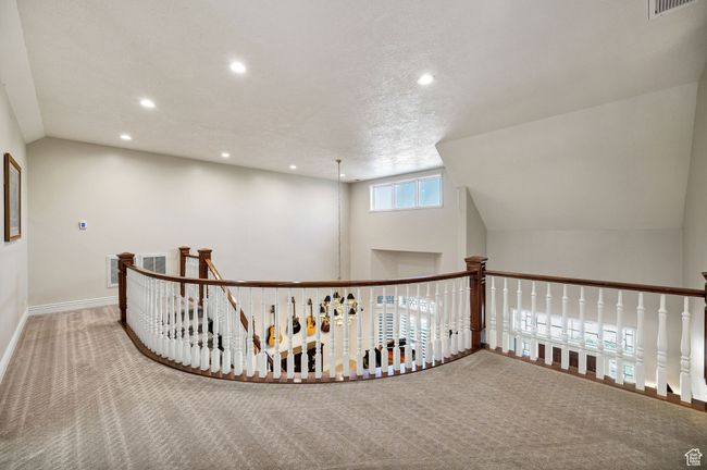 Hallway featuring carpet floors, recessed lighting, an upstairs landing, and lofted ceiling | Image 47