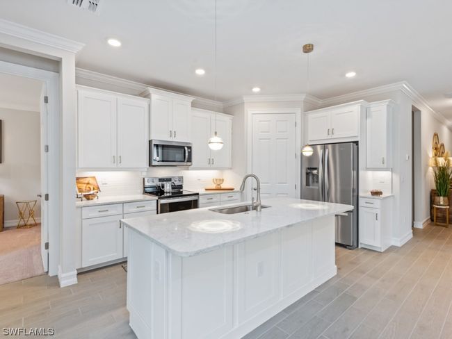 Luxurious modern kitchen with Quartz countertops, Stainless steel appliances, a walk-in pantry and thoughtful design create the ultimate culinary haven! | Image 19