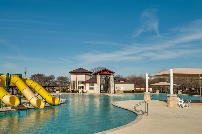 Community pool featuring a water slide, a patio, and a gazebo | Image 28