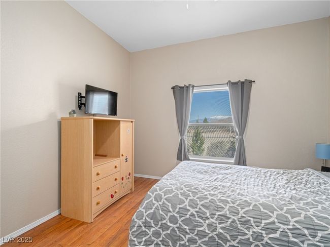 Bedroom featuring baseboards and light wood-style floors | Image 45