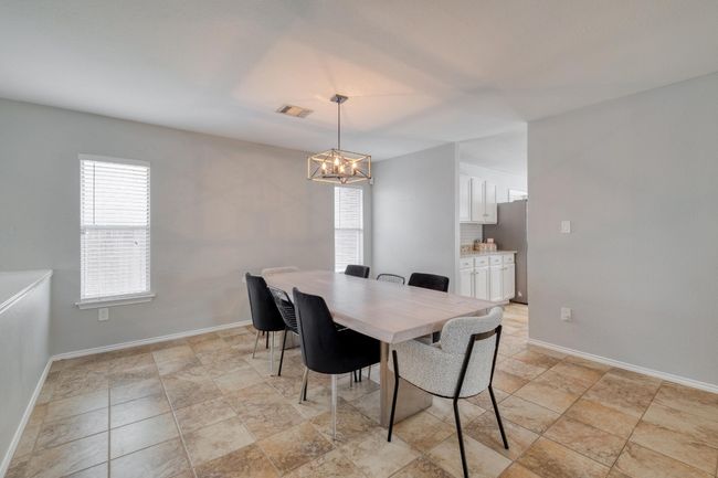 Dining area with a chandelier and baseboards | Image 10