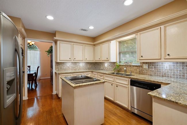 Custom-finish cabinets and a full-size pantry offer tons of storage space for all your food, dishes, and kitchen appliances! | Image 14