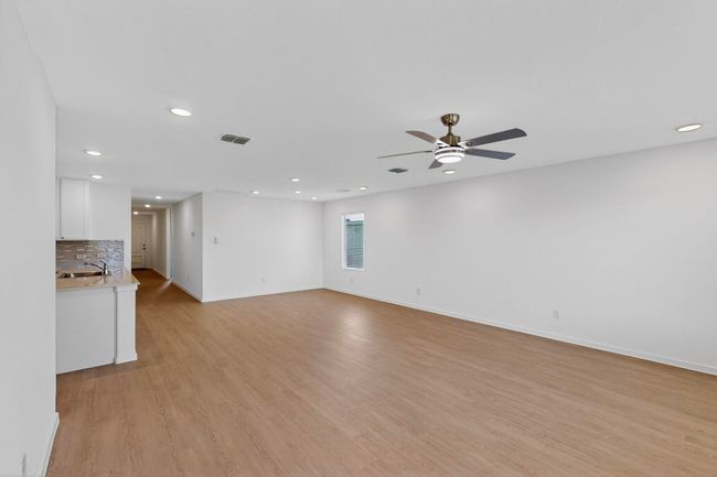 Unfurnished living room featuring a sink, recessed lighting, a ceiling fan, light wood-type flooring, and baseboards | Image 5