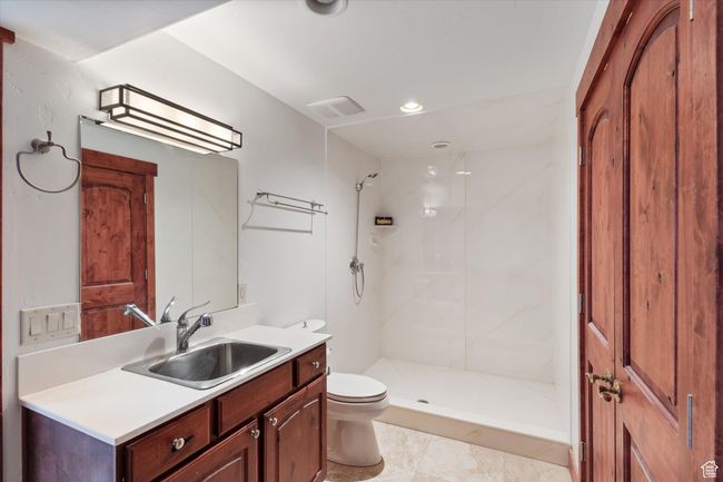 Bathroom featuring recessed lighting, visible vents, toilet, vanity, and a stall shower | Image 18