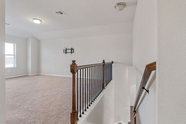 Stairway with baseboards, lofted ceiling, visible vents, and carpet floors | Image 39