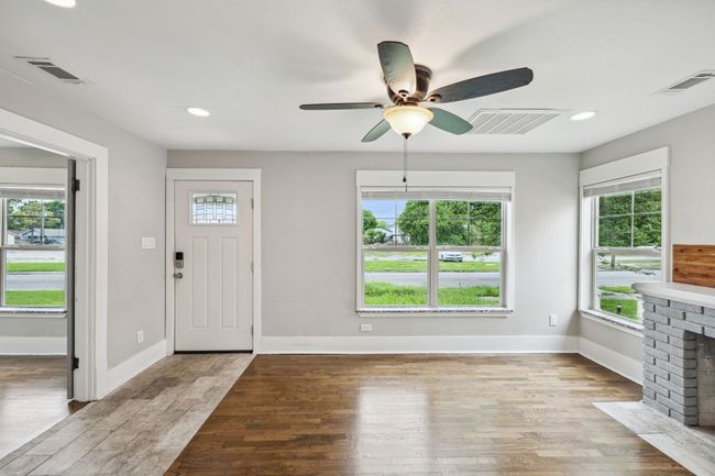 Entryway with light wood-type flooring, recessed lighting, a fireplace, and a ceiling fan | Image 5