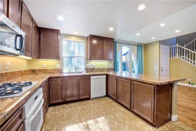 Photo shows kitchen looking toward the dining area beyond | Image 10
