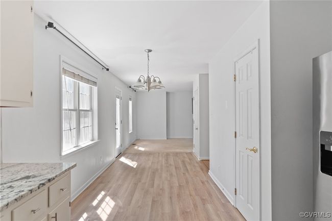 Hall featuring a chandelier and light wood-style flooring | Image 10