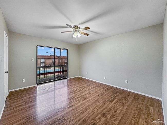 Empty room featuring ceiling fan and hardwood / wood-style floors | Image 13