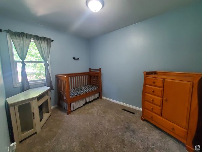 Carpeted bedroom with baseboards | Image 10