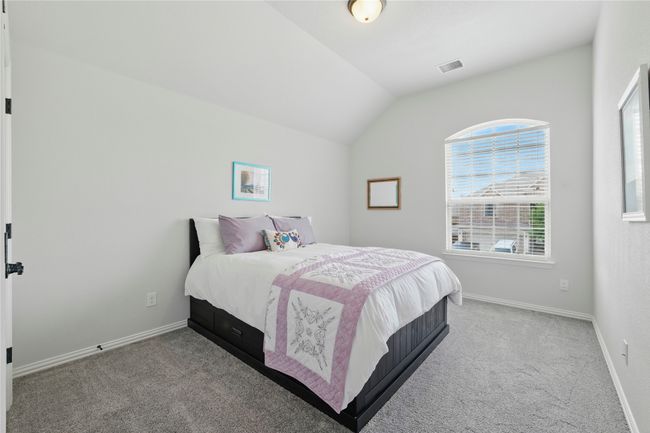 Carpeted bedroom featuring vaulted ceiling and baseboards | Image 33