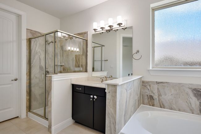 Full bath featuring vanity, a stall shower, a garden tub, and tile patterned flooring | Image 24
