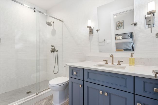 Full bathroom with toilet, a stall shower, ensuite bath, and vanity | Image 13