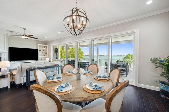 View from dining room toward the backyard and intracoastal water beyond. Here you can also see the large travertine tiled balcony. | Image 23