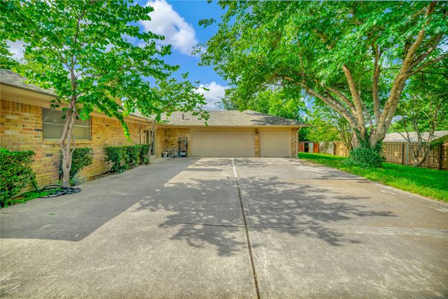 View of front facade with an attached garage, brick siding, and driveway | Image 31