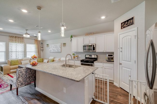 Kitchen featuring stainless steel appliances, a sink, open floor plan, and recessed lighting | Image 11