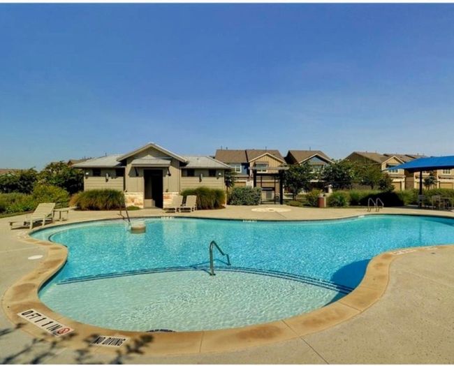 Community pool with a patio area | Image 15