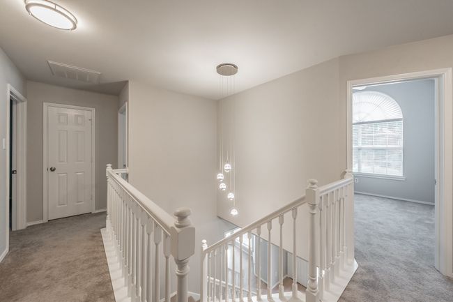 Top of the stairs and beautiful light fixture over the stairway. | Image 32