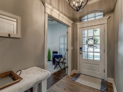 Doorway with a chandelier, hardwood / wood-style floors, and ornamental molding | Image 3