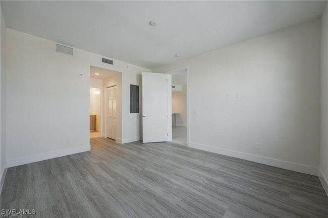 Spare room with baseboards, wood finished floors, and visible vents | Image 21