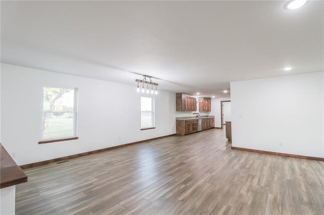 Unfurnished living room featuring plenty of natural light and hardwood / wood-style floors | Image 13