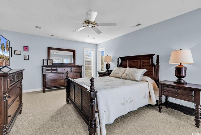 Bedroom with light carpet, baseboards, visible vents, and ceiling fan | Image 18