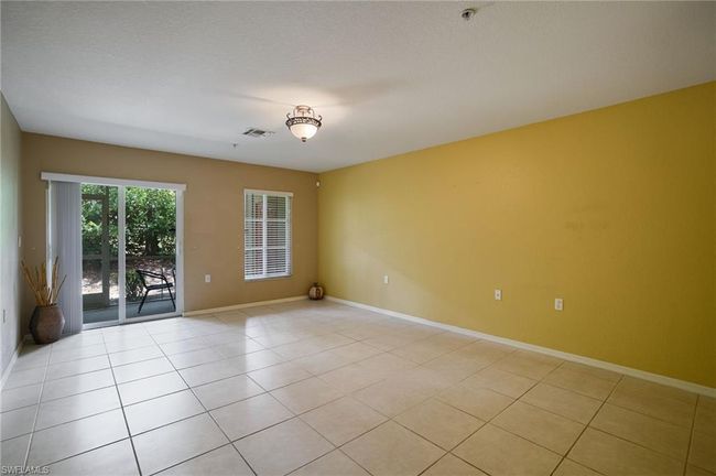 Spare room with light tile patterned floors and a pendent fire sprinkler | Image 5