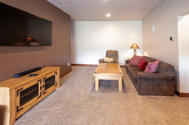 Carpeted living area featuring baseboards | Image 49