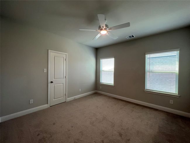 Carpeted spare room with a ceiling fan and baseboards | Image 15