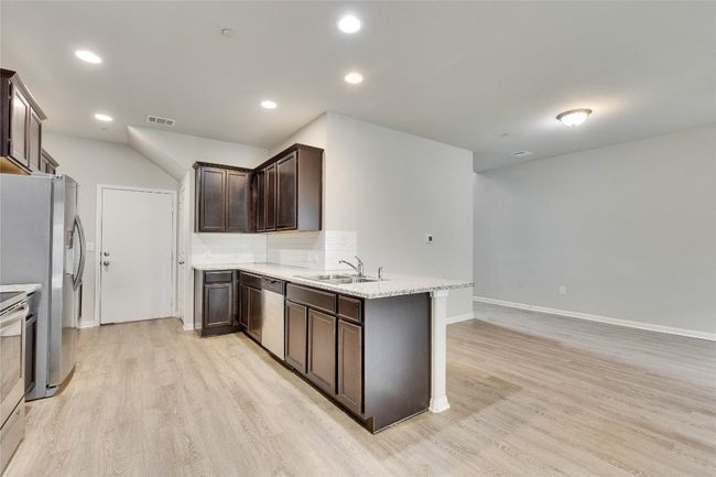 The kitchen has stainless steel, appliances and granite counters. The refrig conveys. | Image 10