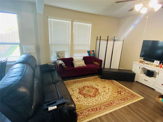 Living room featuring ceiling fan and wood finished floors | Image 11