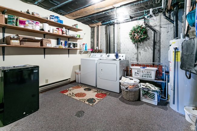 Laundry area featuring a baseboard heating unit, water heater, washer and clothes dryer, and carpet floors | Image 21