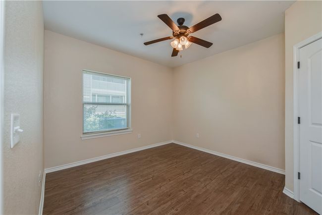 Unfurnished room featuring baseboards, ceiling fan, and dark wood finished floors | Image 10