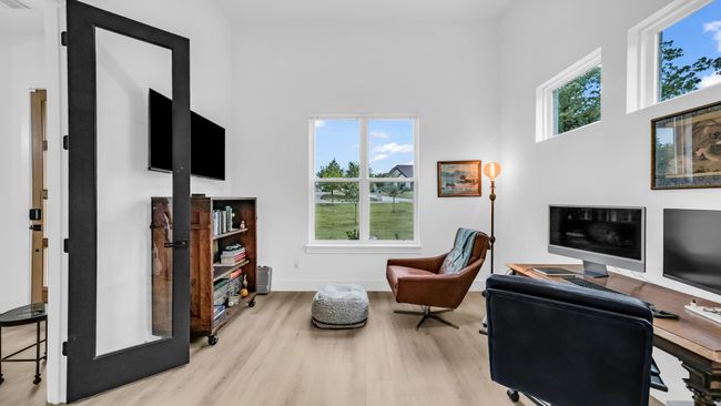 Office space featuring wood finished floors, a high ceiling, and baseboards | Image 8