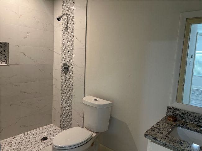 Walk in shower and toilet in full bath in guest house | Image 34