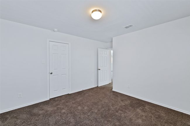 Unfurnished room featuring dark carpet and baseboards | Image 25