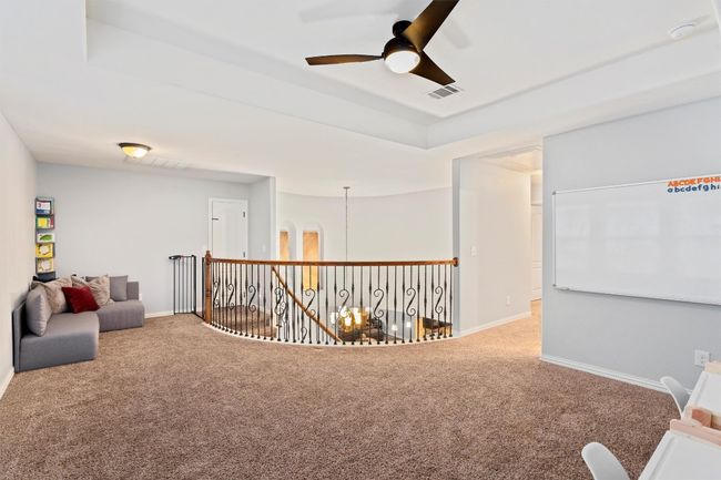 Sitting room featuring carpet, a ceiling fan, and a raised ceiling | Image 25