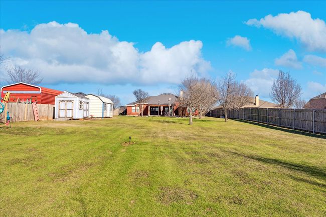 Generous backyard with plenty of room for a pool and space for play equipment or games, ideal for outdoor fun and relaxation. | Image 27