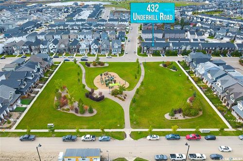 Expansive community park with green spaces and recreational equipment | Card Image