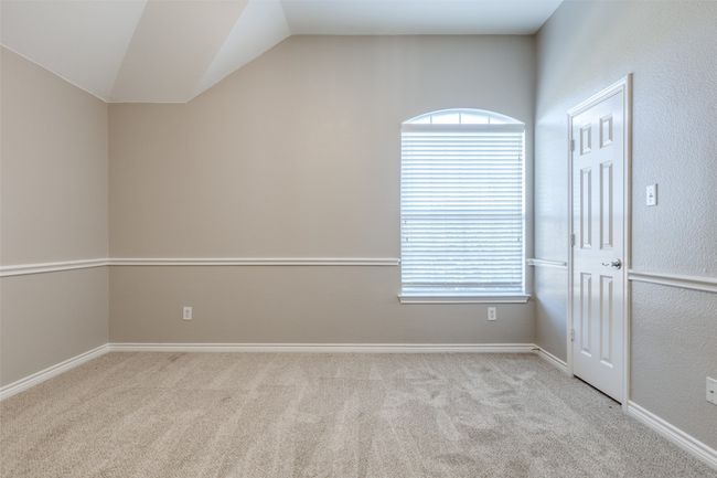 Carpeted spare room with vaulted ceiling, a healthy amount of sunlight, and baseboards | Image 21
