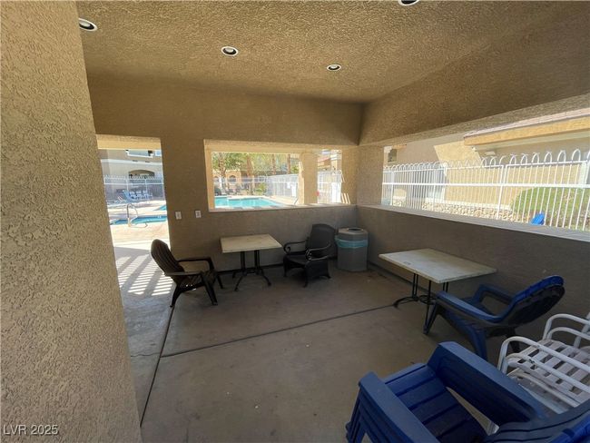 View of patio / terrace with a community pool and fence | Image 50